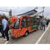 MotoEV Electro Transit Buddy 9 Passenger Hard Door Shuttle custom orange-green outside